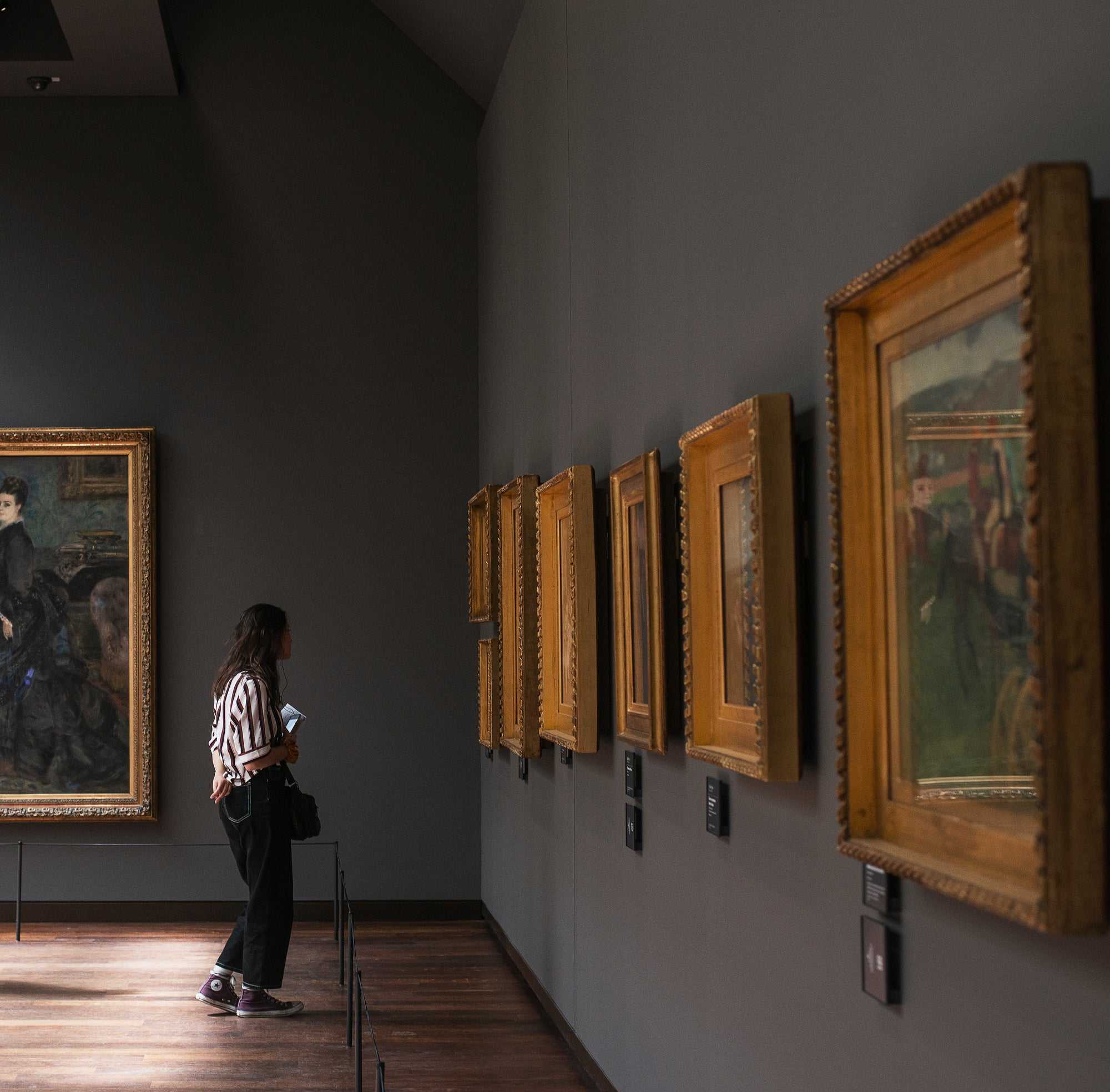 Woman staring at art in a gallery